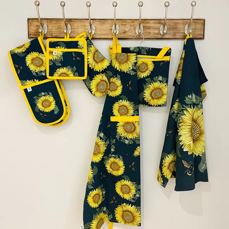 Adult apron made from sustainable cotton featuring a vibrant sunflower and bee print, designed in collaboration with the RHS.