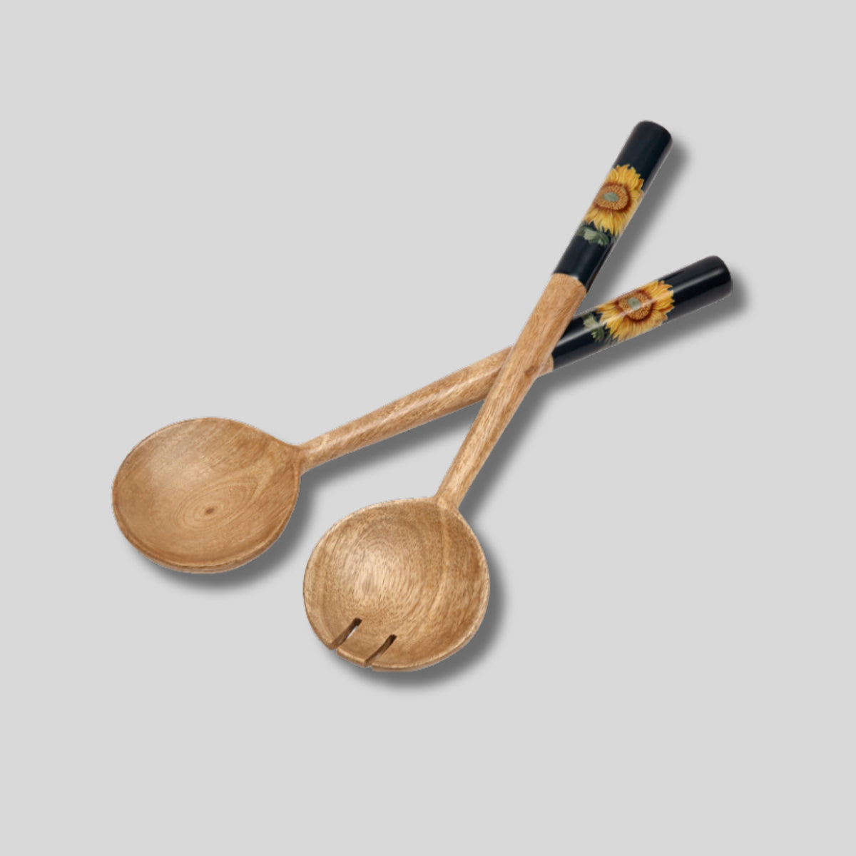 Navy blue mango wood salad servers with enamelled handles, featuring a sunflower and bee design, styled for outdoor dining.